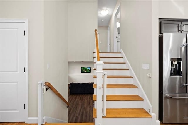 stairway featuring wood finished floors