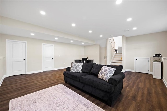 living room with recessed lighting, baseboards, dark wood-style flooring, and stairs