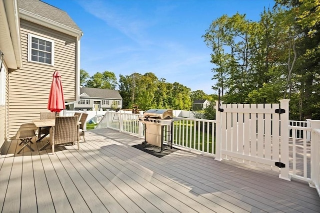 wooden terrace featuring outdoor dining area