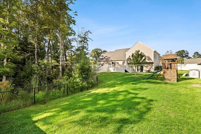 view of yard with a playground and fence