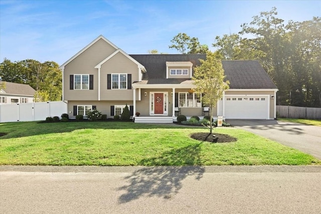 tri-level home with driveway, a front yard, a garage, and fence