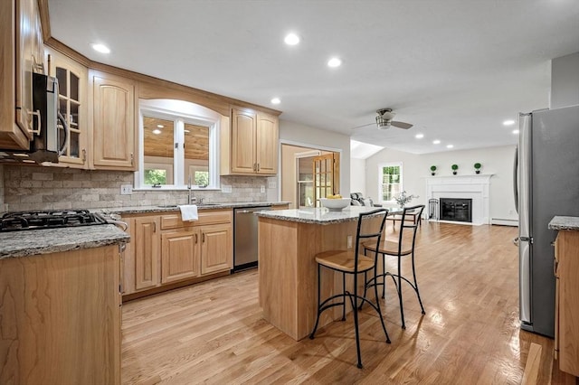 14 Nourse St, Westborough, MA 01581 - kitchen with stainless steel appliances, a ceiling fan, open floor plan, decorative backsplash, and a center island