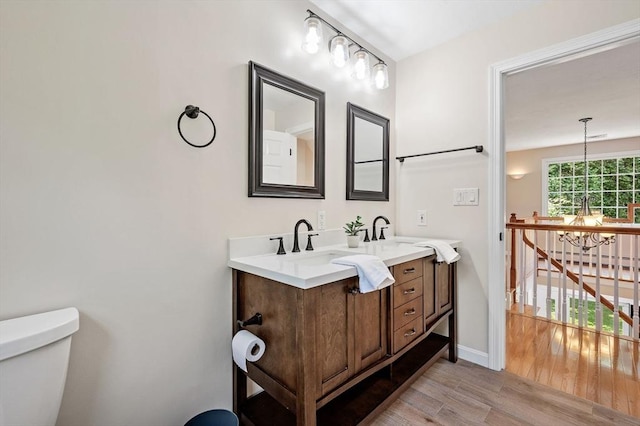14 Nourse St, Westborough, MA 01581 - bathroom featuring wood finished floors, double vanity, and a chandelier