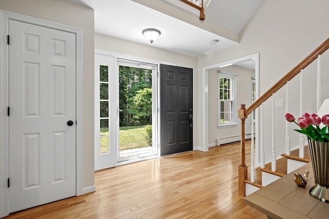 14 Nourse St, Westborough, MA 01581 - foyer with a baseboard radiator, stairs, and light wood-type flooring