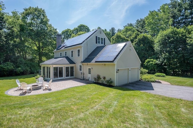 14 Nourse St, Westborough, MA 01581 - back of house with a fire pit, asphalt driveway, a chimney, a patio area, and a yard