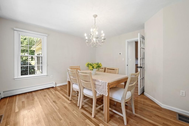 14 Nourse St, Westborough, MA 01581 - dining area featuring a chandelier, light wood-style floors, and a baseboard heating unit