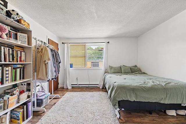 837 Partridgeville Rd Unit 2B, Athol, MA 01331 - bedroom featuring a baseboard radiator, cooling unit, a textured ceiling, and wood finished floors