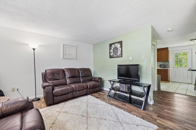 837 Partridgeville Rd Unit 2B, Athol, MA 01331 - living area featuring light wood-style floors and a textured ceiling