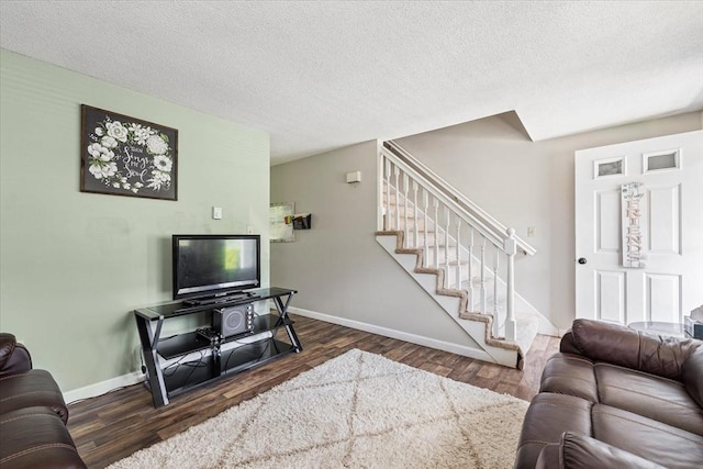 837 Partridgeville Rd Unit 2B, Athol, MA 01331 - living room with stairs, dark wood-style flooring, and a textured ceiling