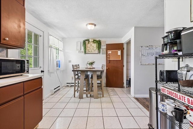 837 Partridgeville Rd Unit 2B, Athol, MA 01331 - dining area with a textured ceiling, light tile patterned flooring, and a baseboard heating unit