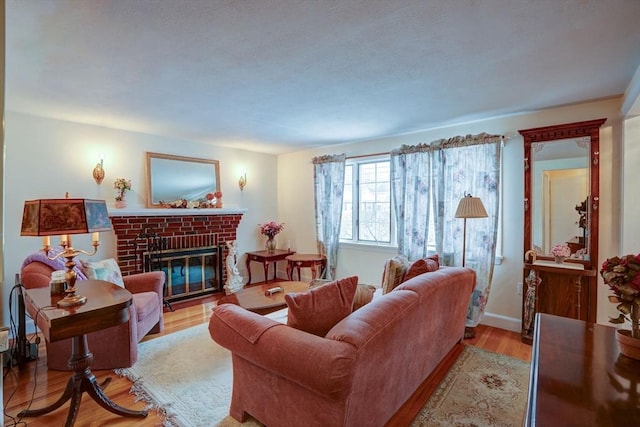 living room featuring light wood-type flooring and a fireplace