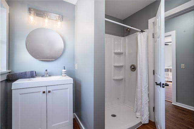 bathroom with wood-type flooring, vanity, and curtained shower