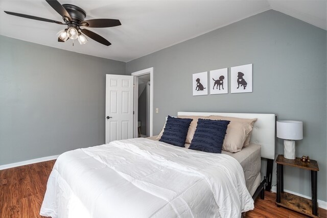 bedroom with lofted ceiling, dark hardwood / wood-style flooring, and ceiling fan