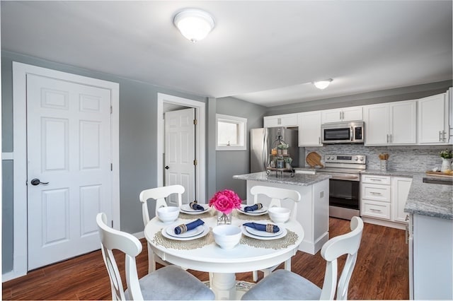 dining area with sink and dark hardwood / wood-style flooring