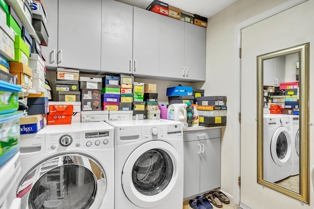 laundry room with cabinets and washing machine and dryer