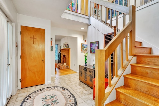 tiled foyer entrance with a fireplace