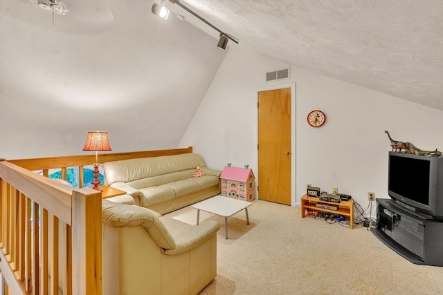 carpeted living room with track lighting, a textured ceiling, and vaulted ceiling