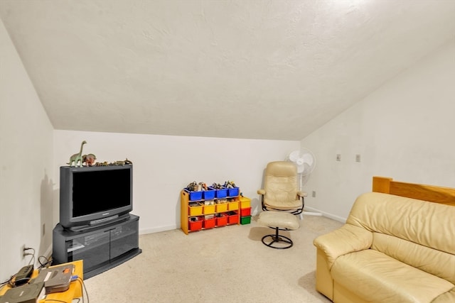 recreation room featuring carpet and vaulted ceiling