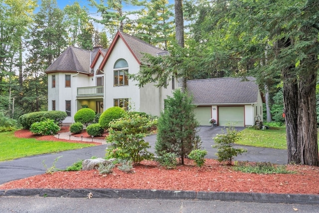 view of front of home featuring a balcony and a garage