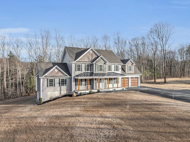 view of front of home featuring a porch and a garage