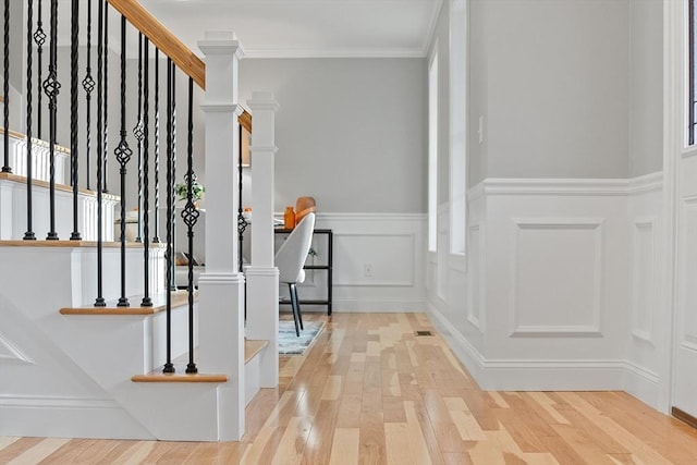 foyer featuring wood-type flooring and ornamental molding