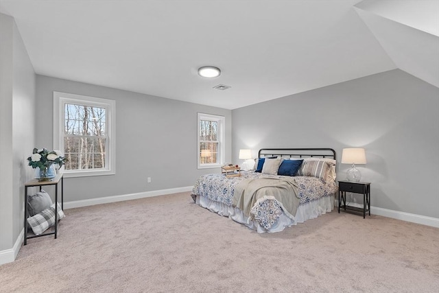 carpeted bedroom featuring multiple windows and vaulted ceiling