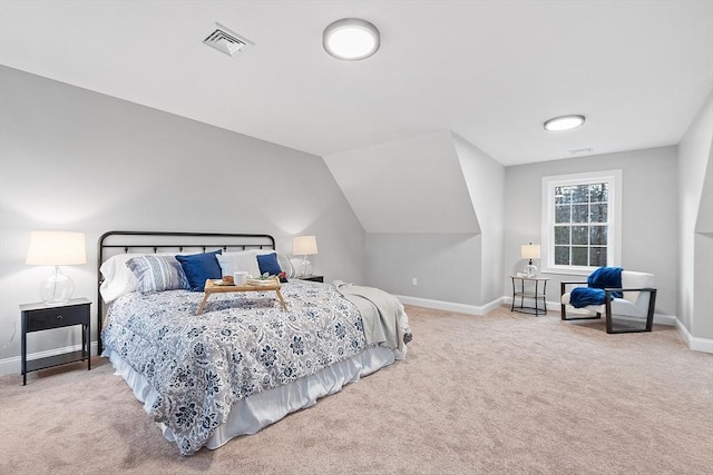 bedroom with carpet floors and vaulted ceiling