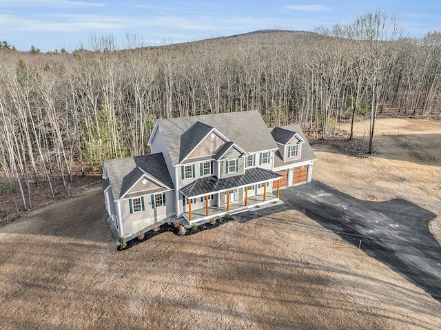 view of front of house featuring a porch and a garage