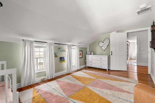 bedroom featuring hardwood / wood-style flooring and vaulted ceiling