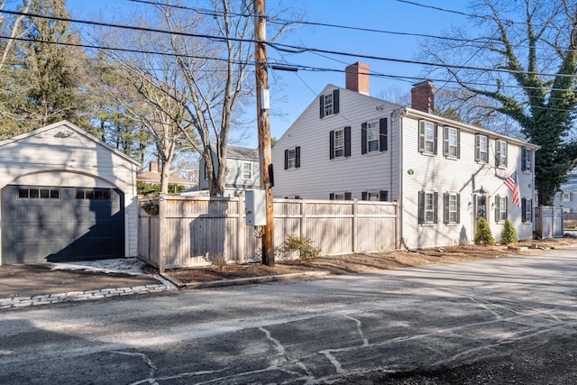 view of property exterior featuring an outbuilding and a garage