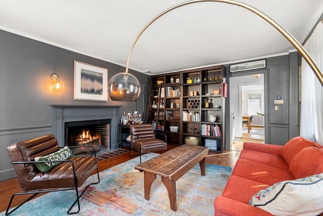 sitting room featuring crown molding and hardwood / wood-style floors