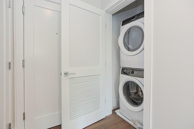 60 Newbury St Unit 10, Quincy, MA 02171 - laundry room featuring stacked washer and clothes dryer and wood finished floors