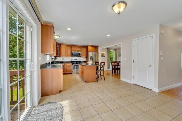 3 White Tail Dr, Tyngsborough, MA 01879 - kitchen featuring appliances with stainless steel finishes, healthy amount of natural light, light tile patterned flooring, brown cabinetry, and recessed lighting