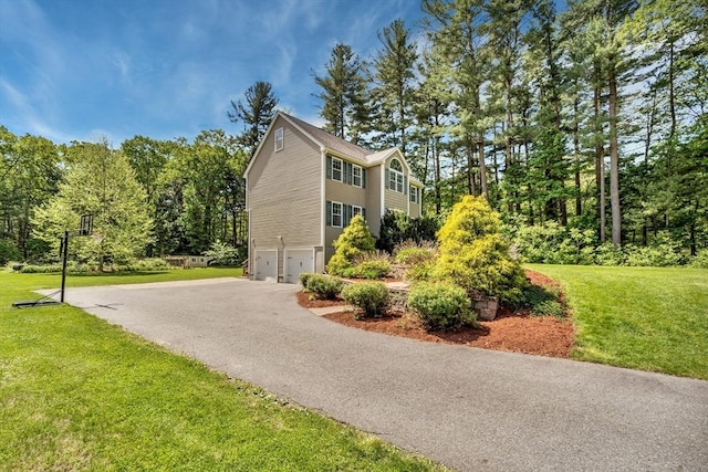 3 White Tail Dr, Tyngsborough, MA 01879 - view of home's exterior featuring a garage, asphalt driveway, and a lawn
