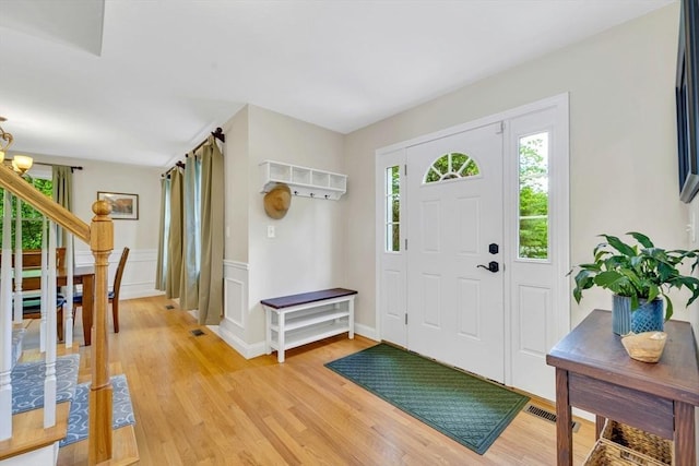 3 White Tail Dr, Tyngsborough, MA 01879 - foyer entrance featuring light wood finished floors, a wainscoted wall, a chandelier, and stairway