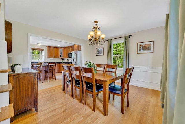 3 White Tail Dr, Tyngsborough, MA 01879 - dining room featuring a chandelier, healthy amount of natural light, light wood-style floors, and wainscoting