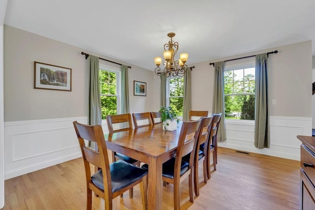 3 White Tail Dr, Tyngsborough, MA 01879 - dining area featuring a chandelier, light wood-type flooring, and wainscoting