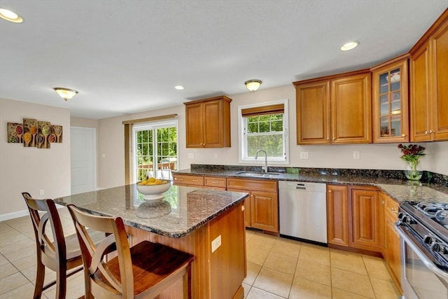 3 White Tail Dr, Tyngsborough, MA 01879 - kitchen featuring dishwasher, a sink, a breakfast bar, brown cabinetry, and light tile patterned flooring