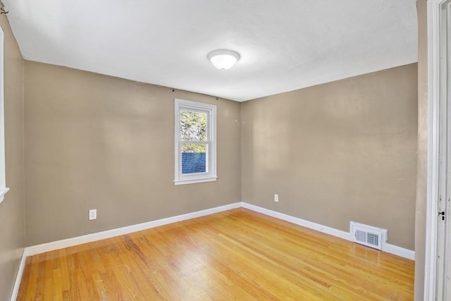 empty room with hardwood / wood-style flooring