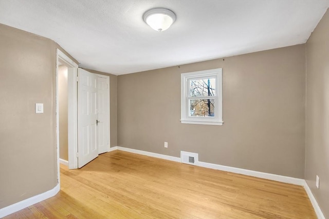 unfurnished room with light hardwood / wood-style floors