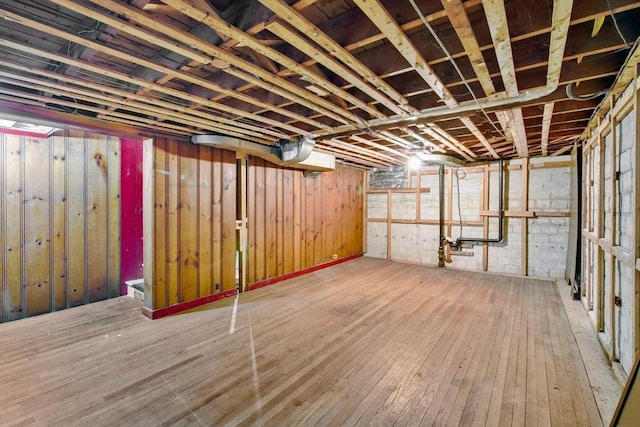 basement with hardwood / wood-style flooring