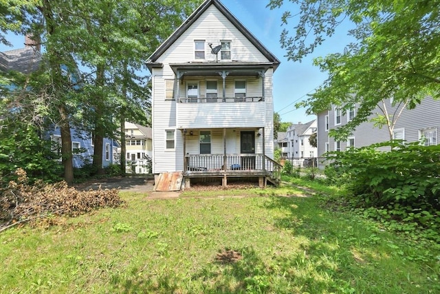 53 Euclid Ave, Springfield, MA 01108 - rear view of house featuring a balcony, a porch, and a lawn