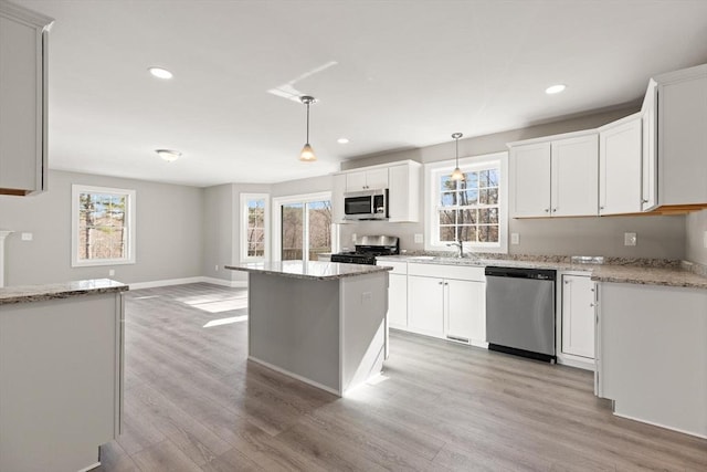 13R Pine Hill Way Unit 13, Harvard, MA 01451 - kitchen with recessed lighting, a healthy amount of sunlight, appliances with stainless steel finishes, and light wood finished floors