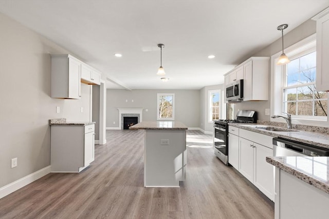 13R Pine Hill Way Unit 13, Harvard, MA 01451 - kitchen featuring a center island, baseboards, appliances with stainless steel finishes, and a healthy amount of sunlight