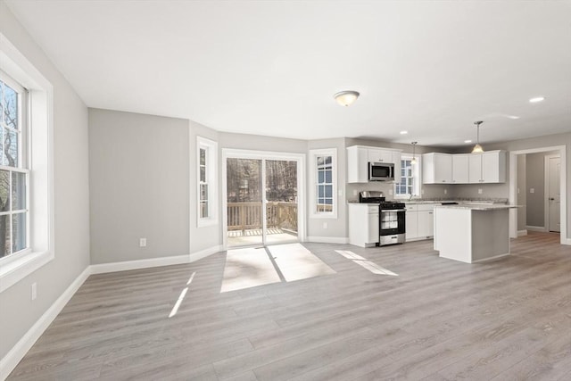 13R Pine Hill Way Unit 13, Harvard, MA 01451 - unfurnished living room featuring recessed lighting, light wood-style flooring, and baseboards