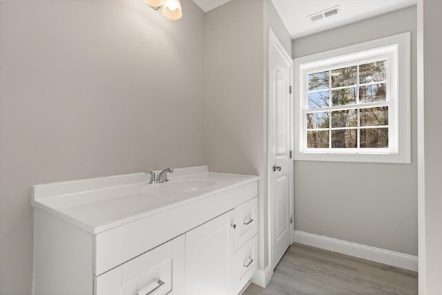 13R Pine Hill Way Unit 13, Harvard, MA 01451 - bathroom with vanity, visible vents, wood finished floors, and baseboards