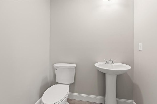 13R Pine Hill Way Unit 13, Harvard, MA 01451 - half bathroom with baseboards, wood finished floors, toilet, and a sink