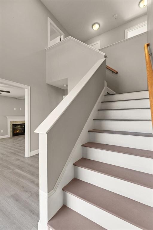 13R Pine Hill Way Unit 13, Harvard, MA 01451 - stairs with a glass covered fireplace, wood finished floors, and baseboards