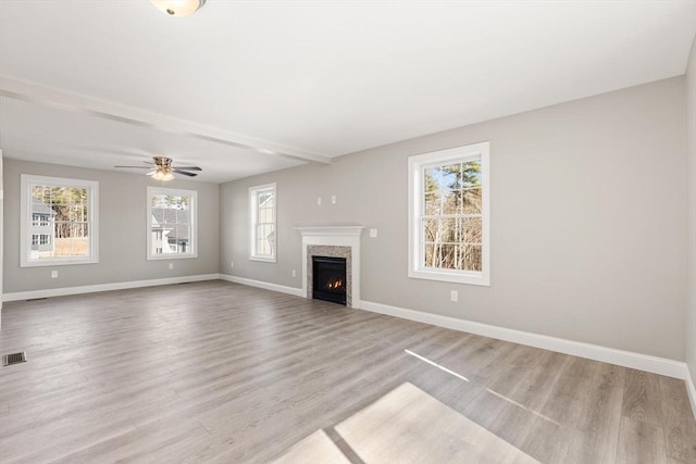 13R Pine Hill Way Unit 13, Harvard, MA 01451 - unfurnished living room with visible vents, ceiling fan, a lit fireplace, baseboards, and light wood finished floors