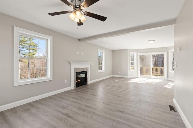 13R Pine Hill Way Unit 13, Harvard, MA 01451 - unfurnished living room featuring a premium fireplace, baseboards, ceiling fan, and plenty of natural light